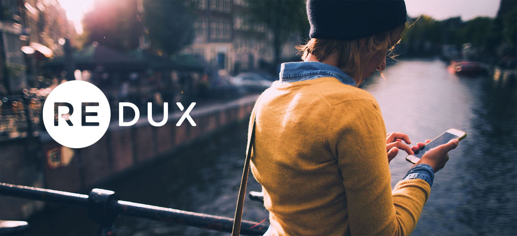 Redux Header with Lady Holding Phone