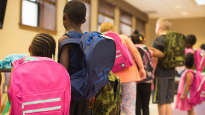 Children with backpacks on