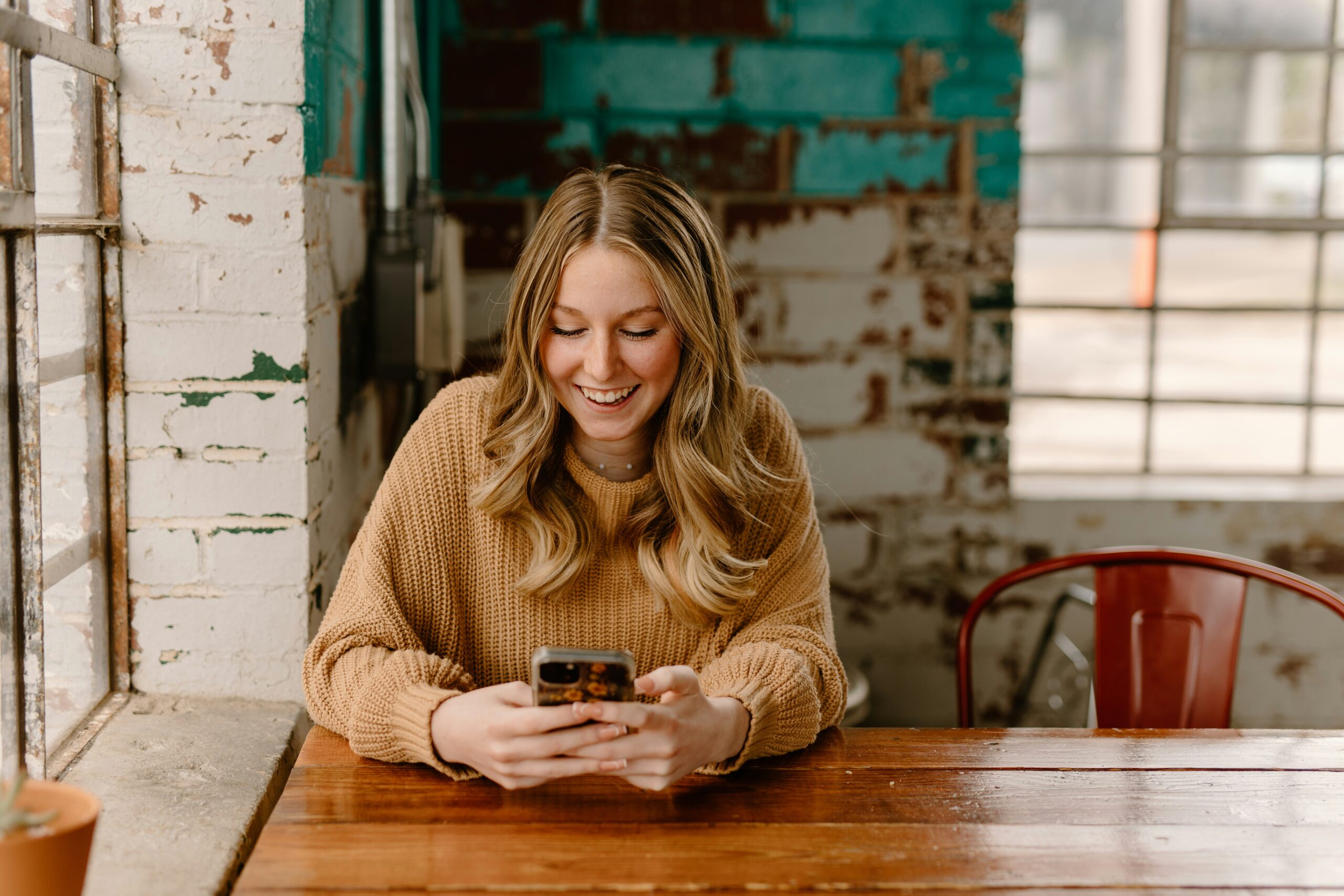 Girl smiling and looking at phone