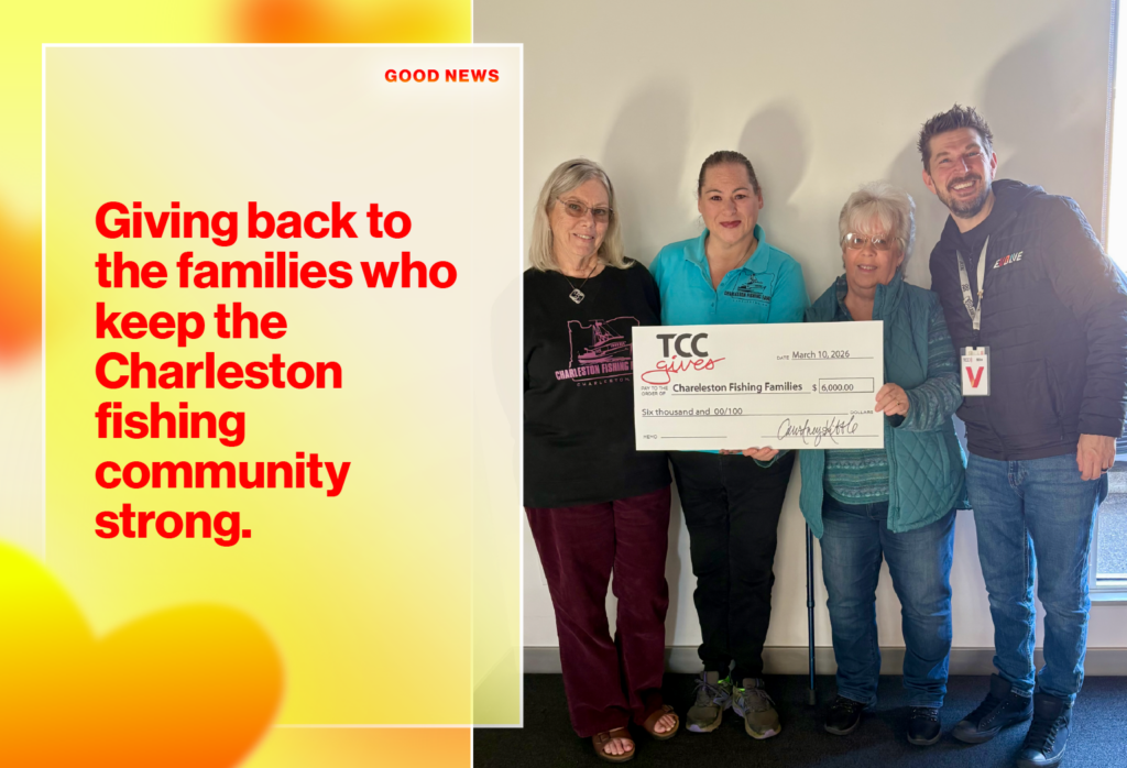 Group of four people holding a large donation check labeled 'TCC gives Charleston Fishing Families' and smiling at the camera; signifies a charitable donation to the fishing community.